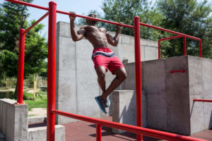 the fit athlete doing exercises at stadium afro or african american man outdoor at city pull up sport exercises fitness health lifestyle concept scaled